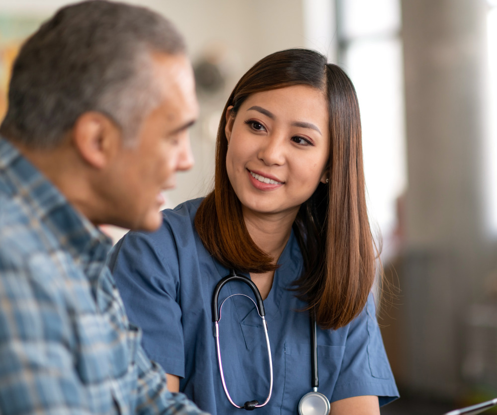 Careers Health care staff taking time to talk with a senior resident