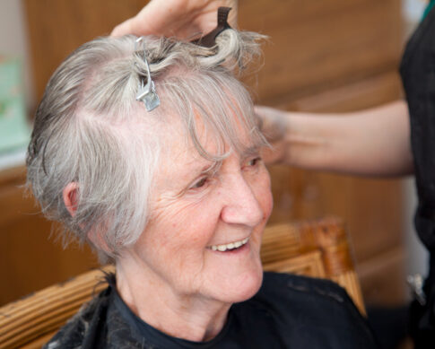 A senior woman getting her hair done